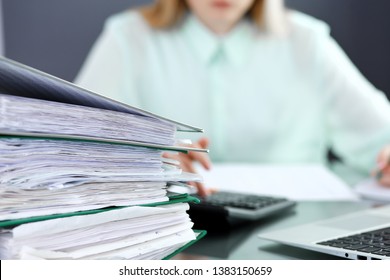 Bookkeeper or financial inspector  making report, calculating or checking balance. Audit and tax service concept. Green colored image background 