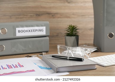 Bookkeeper's workplace with folders and documents on table - Shutterstock ID 2127492326