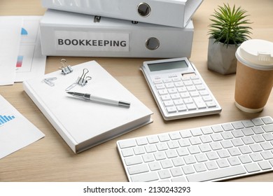 Bookkeeper's workplace with folders and documents on table - Shutterstock ID 2130243293