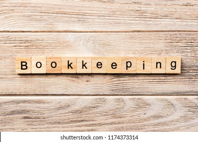 bookkeeping word written on wood block. bookkeeping text on table, concept. - Shutterstock ID 1174373314