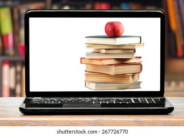 Books And Apple On Laptop Screen