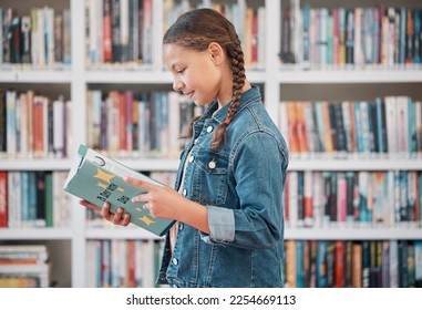 Books, education or child in a library reading for knowledge or development for future growth. Scholarship, girl or school student with a happy smile studying or learning information in a fun story - Powered by Shutterstock