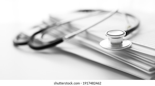 Books Folder File With Medical Data And Stethoscope Isolated On White Background