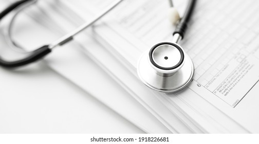 Books Folder File With Medical Data And Stethoscope Isolated On White Background