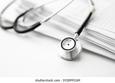 Books Folder File With Medical Data And Stethoscope Isolated On White Background