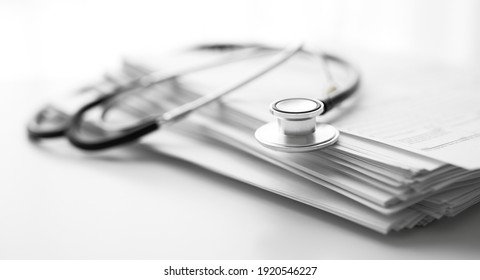 Books Folder File With Medical Data And Stethoscope Isolated On White Background