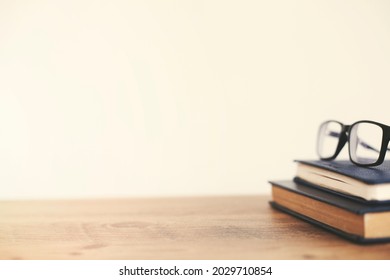 Books And Glasses On The Wooden Table