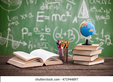 Books with globe on the school desk - Shutterstock ID 471944897