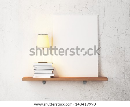 books, lamp and blank poster on a shelf 