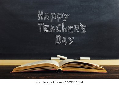 Books lie on the background of the chalk board. The concept of study or the day of the teacher. Copy space. - Shutterstock ID 1462141034