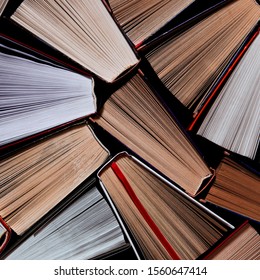 Books. Lots Of Colourful Thick Open Books Stand On A Dark Background