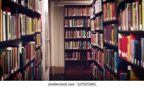 Books on bookshelves in the public library room background. School book in bookshelf beautiful concept. - Shutterstock ID 1275272401