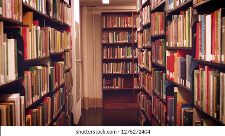Books on bookshelves in the public library room blurred background. School book in bookshelf beautiful concept. - Shutterstock ID 1275272404