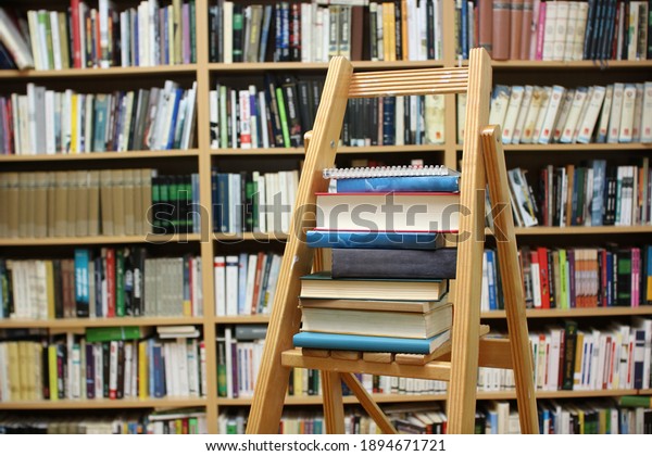 Books on the ladder in the library