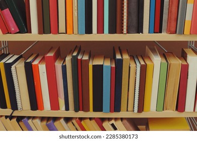 Books on the shelf in library - Shutterstock ID 2285380173