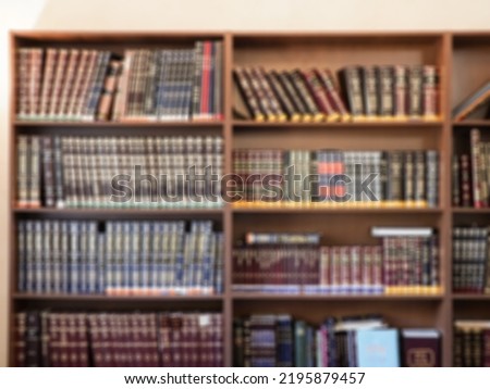Books on the shelves in the library. Defocused image.