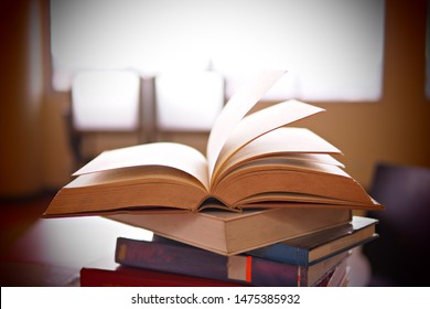 Books On Study Desk In A Library, Education Or Academic Concept Picture Of Learning Materials. School, College, Or University Conceptual Image. Test Or Exam Preparation Prior To The Evaluation Day. 