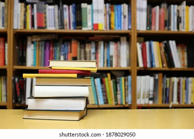 Books on the table in library - Shutterstock ID 1878029050