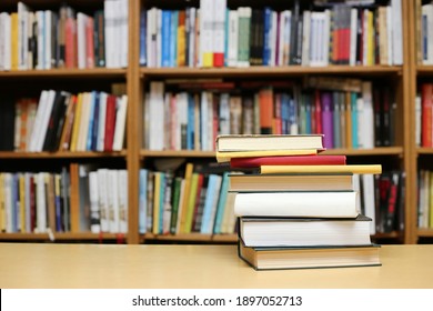 Books on the table in library - Shutterstock ID 1897052713