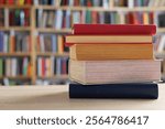 books on wooden background, closeup.stack of books against the background of library, stack of books in front of library, books on wooden table, education, High quality book photography, Best Book,red