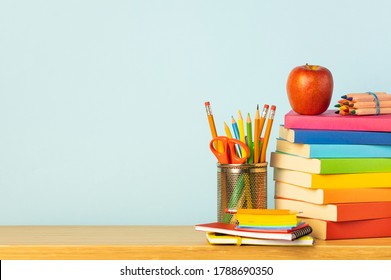 Books and pencil holder on school desk. Back to school concept. - Powered by Shutterstock