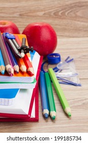 books with school supply and apple  on wooden table - Shutterstock ID 199185734