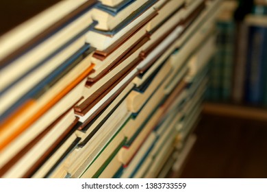 Books in solid overflow on the background of a bookshelf
