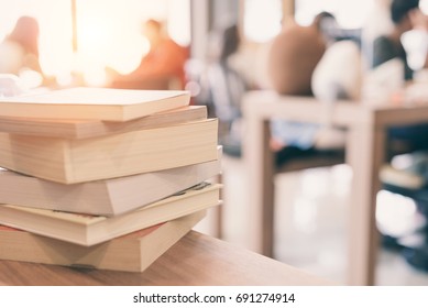 Books Stack On The Library Table. At The Time Of University Student Exams In Selective Focus.