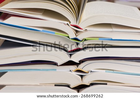 Books. Stack of Open Books on top of other books with the books pages. 