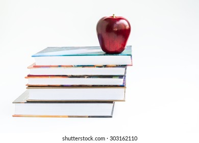 Books stack with red apple
