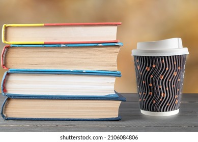 Books Stacked Vertically And A Coffee Cup