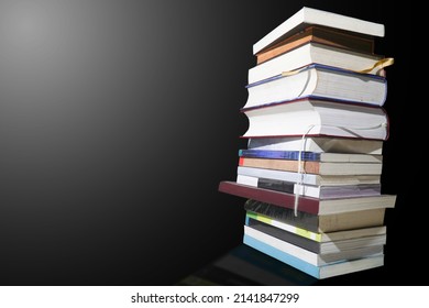 Books Stacked Vertically On A Black Background