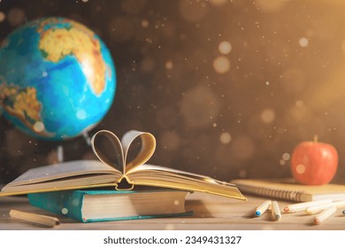 books, stationery on the table on a black chalkboard. Education, September 1, new academic year - Powered by Shutterstock