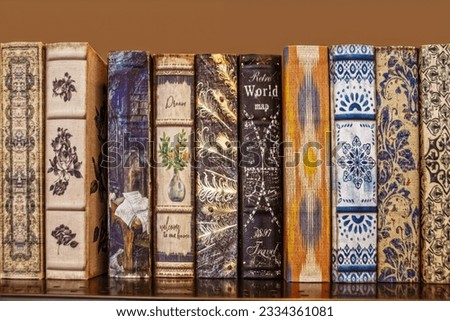 Bookshelf - Decorative boxes designed to look like cloth covered retro books lined up on shelf-room for text