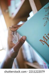 Bookshelf, Library And Books In Student Hand For Learning, Scholarship Education And Knowledge. Person With Print Literature For Research, Search For Inspiration And Studying At University Or College