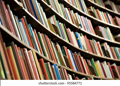 Bookshelf In Library With Many Books. Shallow Dof.