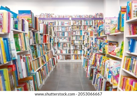 Bookstore interior. Shelves with books. Defocused photo for design needs