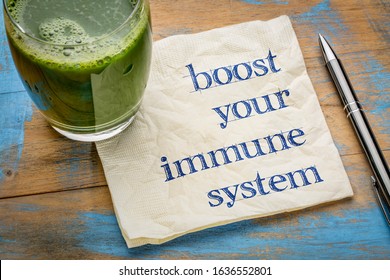 boost your immune system - inspirational handwriting on a napkin with a glass of fresh, green, vegetable juice, healthy lifestyle and wellbeing concept - Shutterstock ID 1636552801