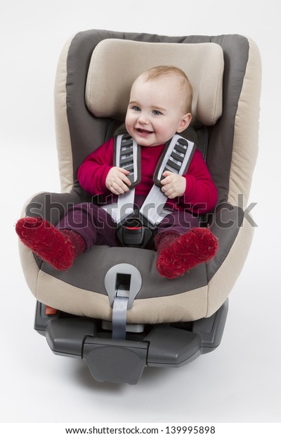 booster seat with child for a car in light\
background. studio shot