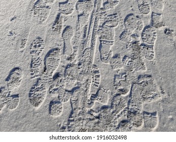 Boot Prints And Bicycle Tracks In The Snow