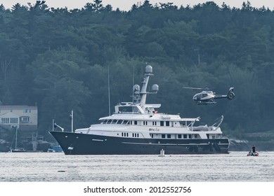 Booth bay Harbor, Maine, USA-July 12, 2021: Helicopter coming in for a landing on luxury yacht anchored in Boothbay Harbor