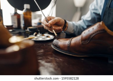 Bootmaker With Brush Tints Shoes, Footwear Repair