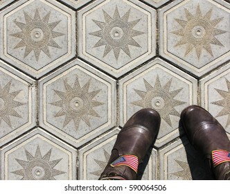 Boots shoes on the tile background outdoor photo - Powered by Shutterstock