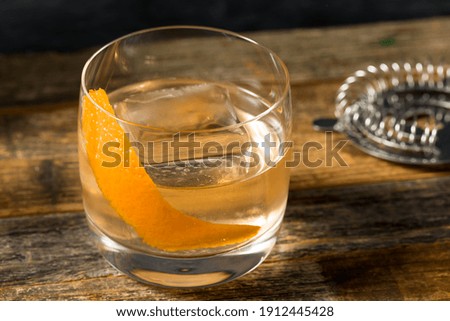 Boozy Moonshine Old Fashioned Cocktail with an Orange Peel 商業照片 © 