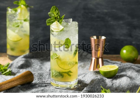 Boozy Refreshing Dark Rum Mojito Cocktail with Lime and Mint