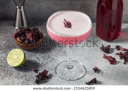 Boozy Refreshing Vodka Hibiscus Pink Cocktail in a Coupe Glass