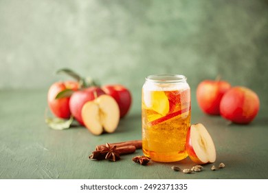 Boozy Refresing Cold Hard Apple Cider in a Pint Glass and Bottle on wooden table. Copy space