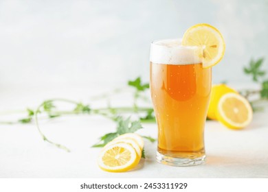 Boozy Refresing Cold Lemon Beer or Radler in a Pint Glass  on the table. - Powered by Shutterstock