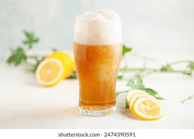 Boozy Refresing Cold Lemon Beer or Radler in a Pint Glass  on the table. - Powered by Shutterstock