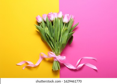 Boquet Of Pink Tulips On The Yellow And Pink Background.Easter,spring Flower Concept,copy Space.Mothers Or Womans Day.